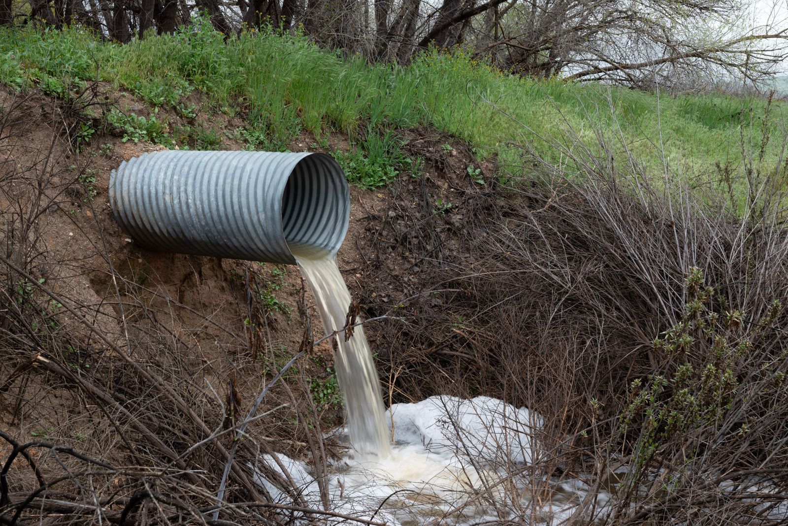 An overflow pipe discharging water into a watercourse